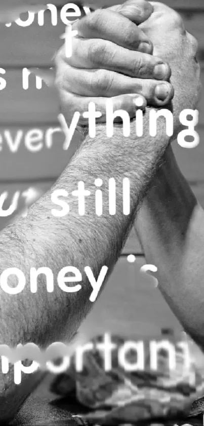 Arm wrestling with quote on importance of money in black and white.