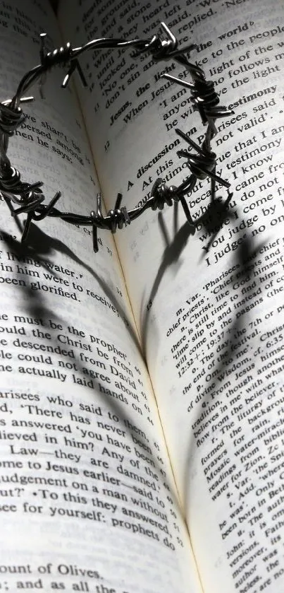 Bible pages with a crown of thorns casting a heart shadow.