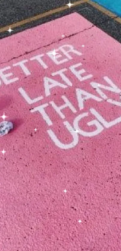 Pink pavement with motivational quote in white.