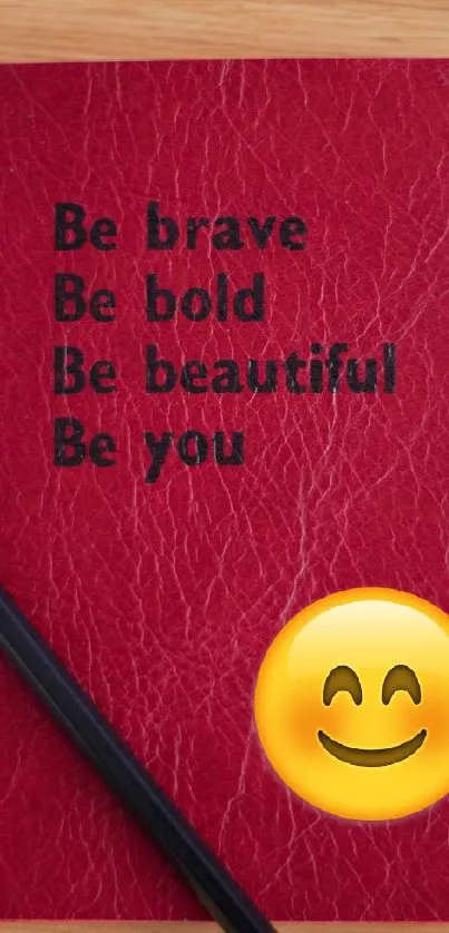 Red notebook with motivational quotes and a smiley emoji.