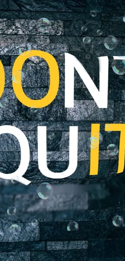 Inspirational 'Don't Quit' text on a dark brick background with bubbles.