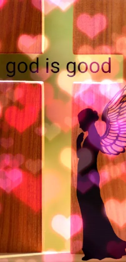 Angel silhouette next to wooden cross with 'god is good' text.