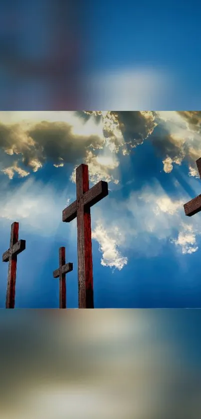 Mobile wallpaper of crosses against a blue cloudy sky.