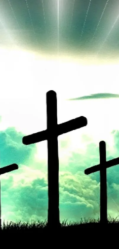 Three crosses silhouetted against a radiant sky with clouds and light rays.