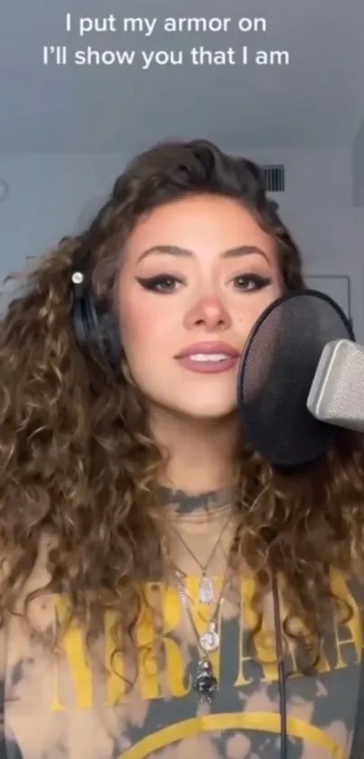 Woman recording music with microphone in a studio.