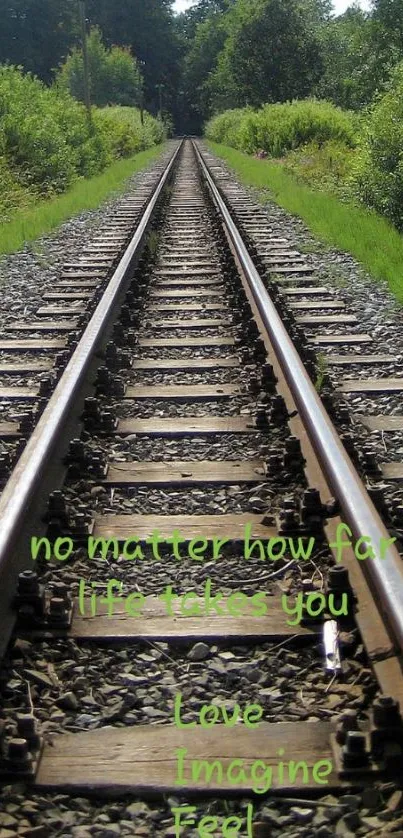 Railroad track through lush greenery with inspirational text.