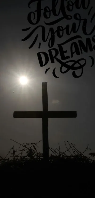 Silhouette of cross at sunset with 'Follow Your Dreams' text.