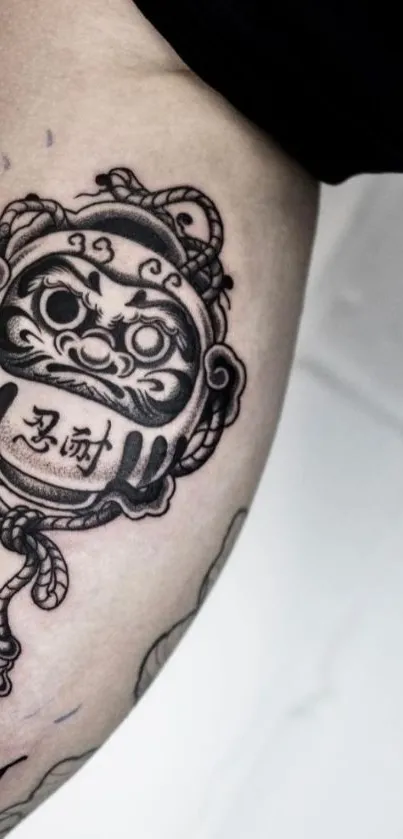 Intricate arm tattoo featuring bold lines and cultural symbolism.