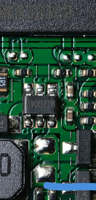 A close-up view of a green circuit board with intricate electronic components.