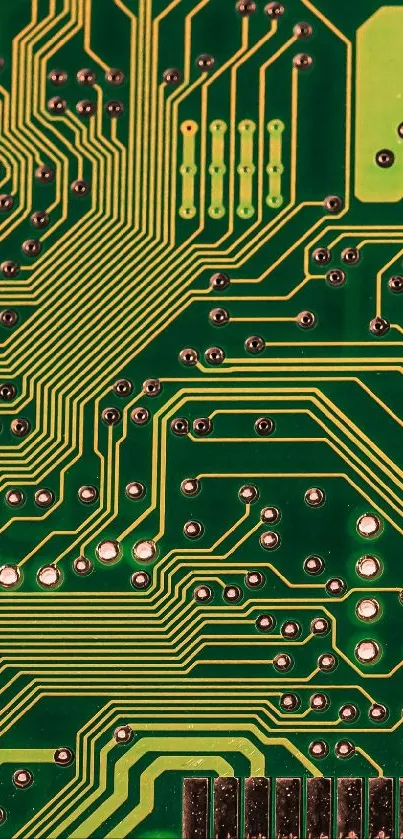 Close-up of a green circuit board pattern with yellow pathways and connections.