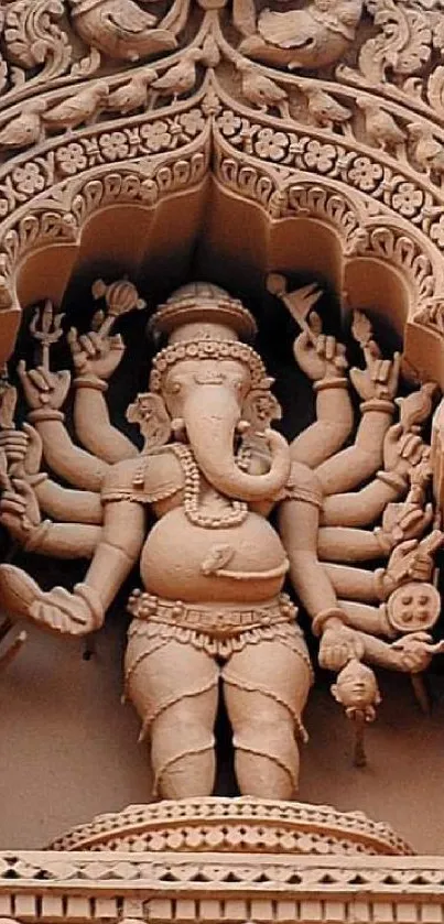 Intricate sandstone carving of Ganesha in a temple.