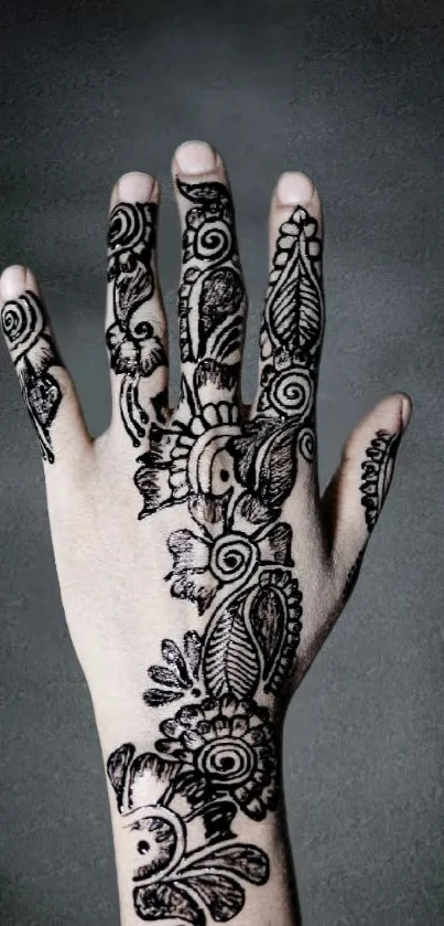 Intricate henna design on a hand in grayscale.