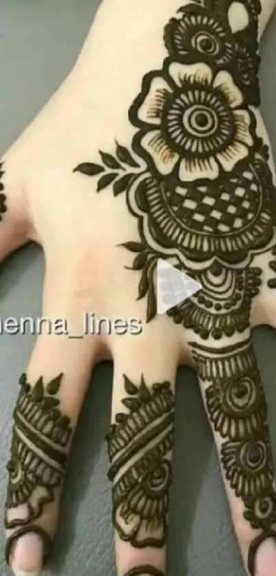 Intricate henna design on a hand with floral patterns.