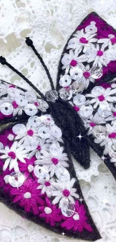 Embroidered butterfly on white lace background, highlighted by magenta and floral details.