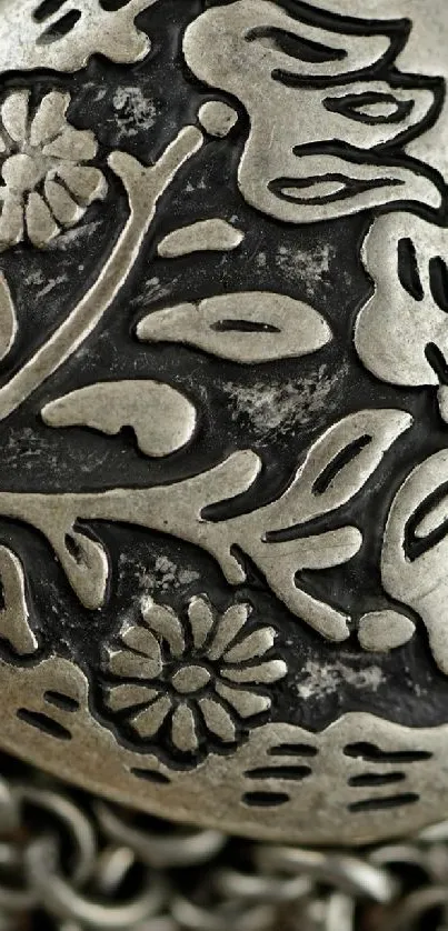 Intricate metal floral design with raised texture.