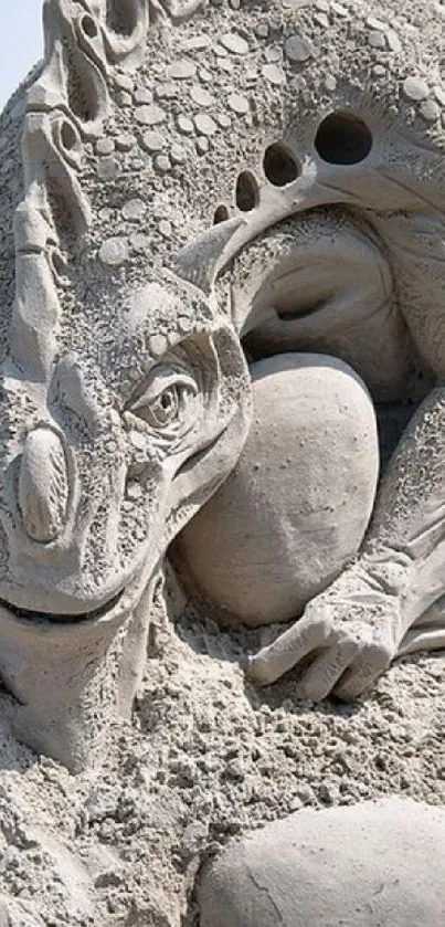 Intricate sand dragon sculpture on the beach.