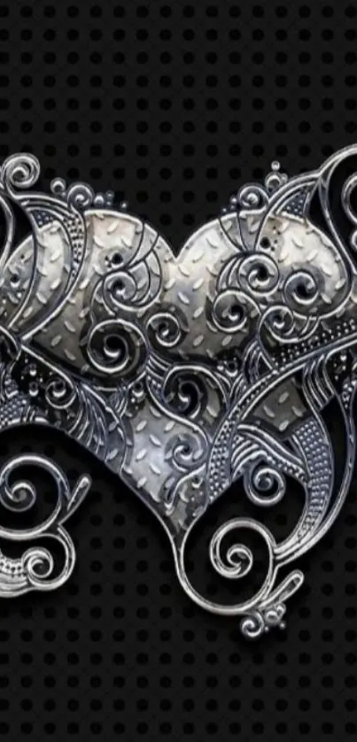 Intricate silver heart design with elegant swirls on black background.