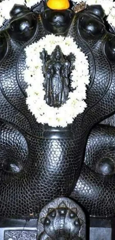 Intricate black Naga statue with white garland for mobile wallpaper.