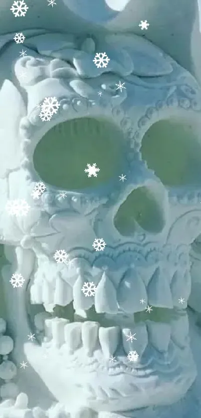 Intricate skull sculpture crafted from snow amidst a snowy landscape.