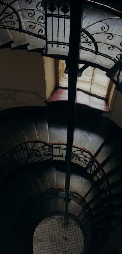 Intricate spiral staircase with vintage iron railing and dark aesthetic.