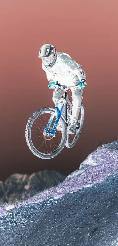 Inverted image of a cyclist jumping on a mountain bike against a burnt orange sky.