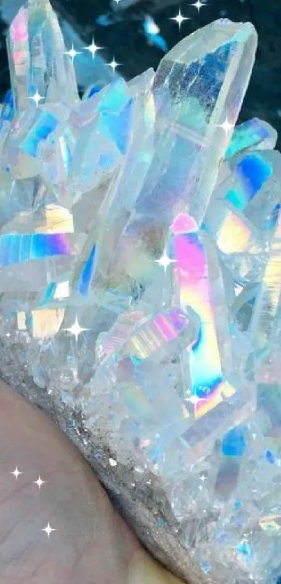 Iridescent crystal formation held in hand, reflecting vibrant colors.