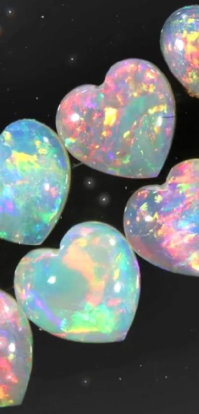 Seven iridescent heart-shaped gems on a black background.