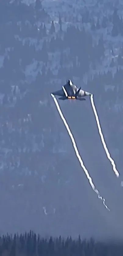 Jet soaring above mountains with vapor trails.