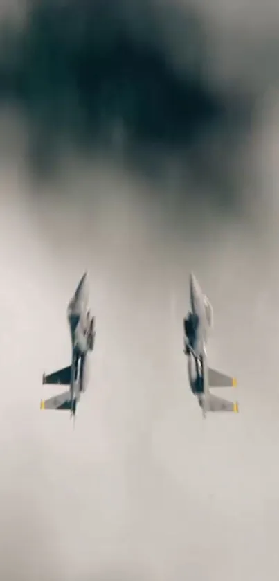 Two jet fighters soar through a cloudy sky, showcasing aerial prowess.