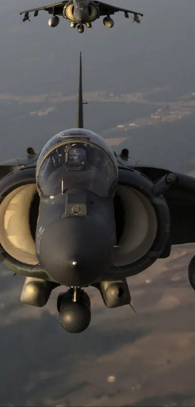 Two jet fighters flying in formation, aerial view.