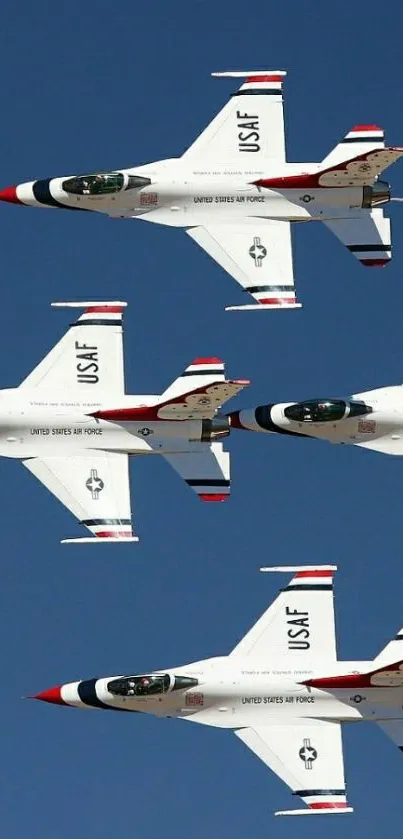 Fighter jets flying in formation against a clear blue sky.