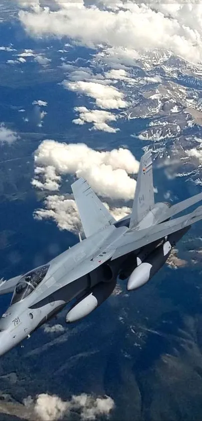 Jet fighter flying high above clouds and mountains