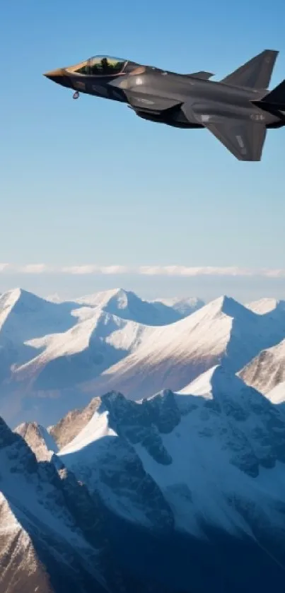 Jet soaring over snow-capped mountains with clear blue sky.