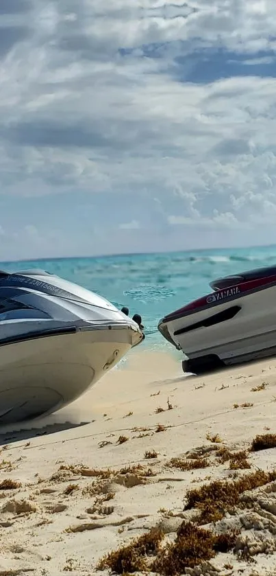 Jet skis on a sandy beach by turquoise water.