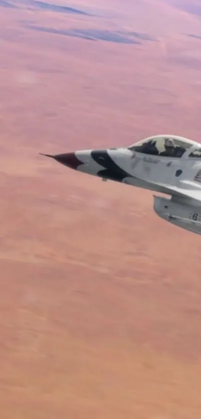 Aerial view of a jet flying over a desert landscape.