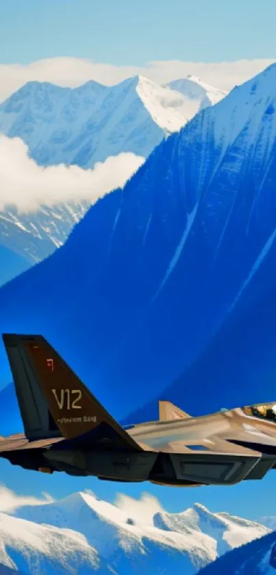 Fighter jet flying over snowy mountains under a blue sky.