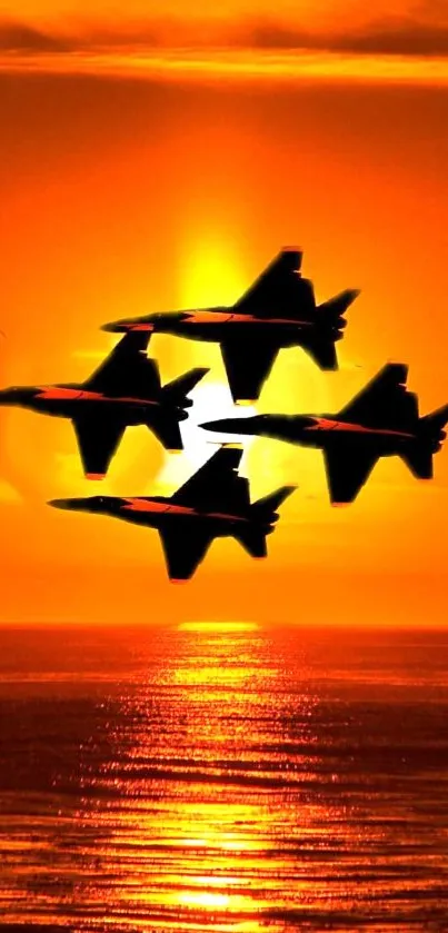 Silhouettes of jets against an orange sunset over the ocean.