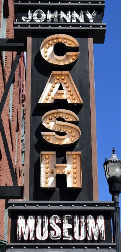 Johnny Cash museum neon sign on brick wall backdrop.