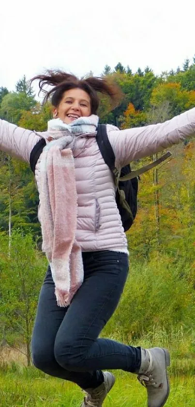 Joyful woman jumping in colorful autumn forest.