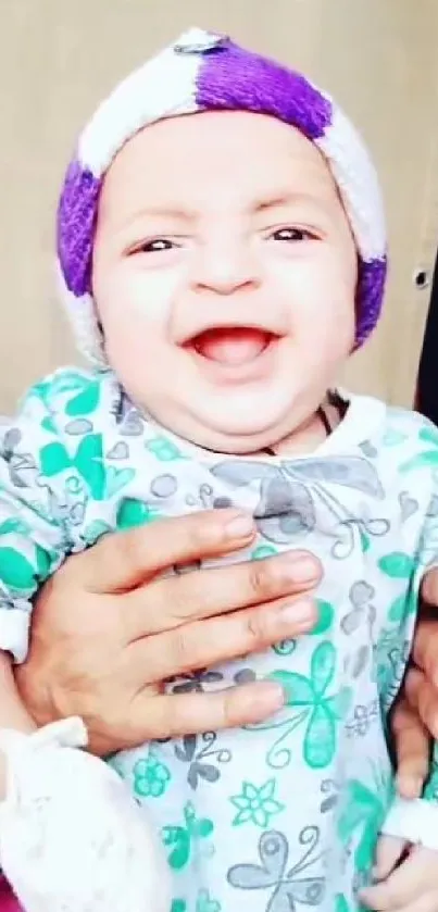 Smiling baby with colorful outfit, radiating joy.