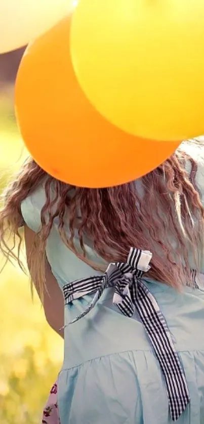 Girl holding balloons in a sunny field.