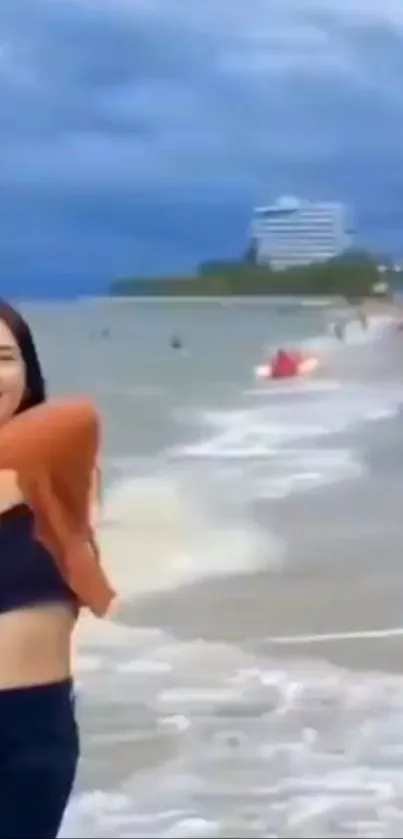 Joyful woman at the beach with blue ocean waves.