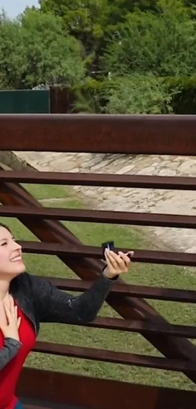 Woman joyfully posing on a bridge by a lush canal.