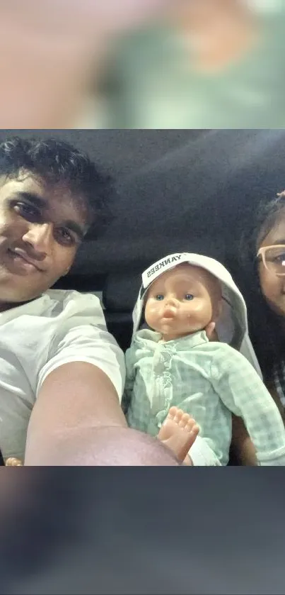 Two friends riding in a car with a doll.