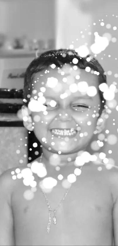 Smiling child in black and white with bokeh lights.