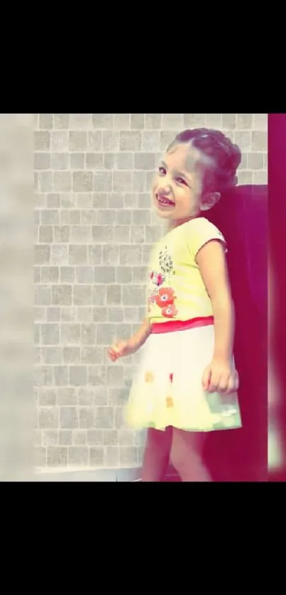 Joyful child in colorful dress with textured backdrop.