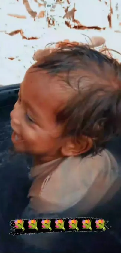 Smiling child in a tub of water enjoying a sunny day.