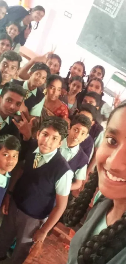 Joyful group of students taking a selfie in a classroom with their teacher.