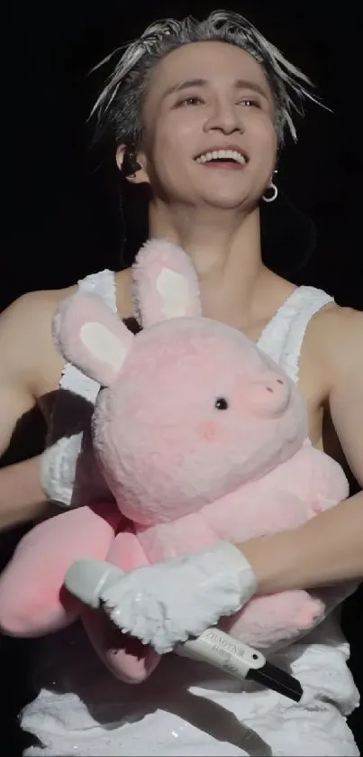 Energetic concert moment with joyful expression holding a plush toy.