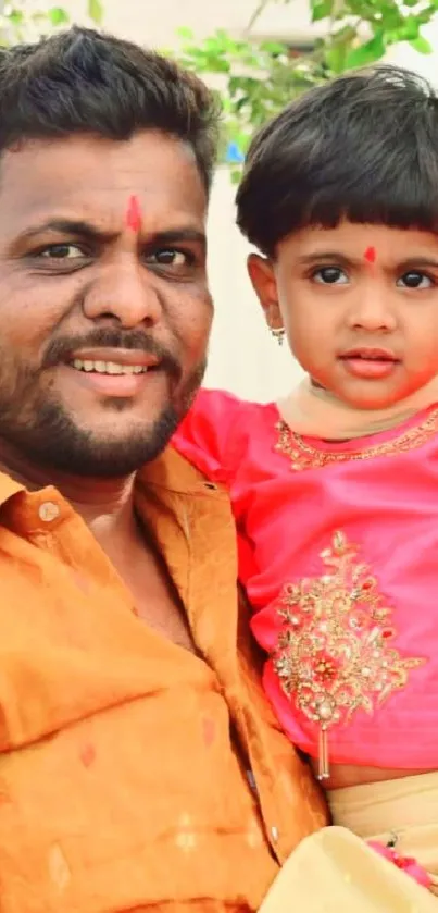 Father holding child in traditional attire with joyful expressions.